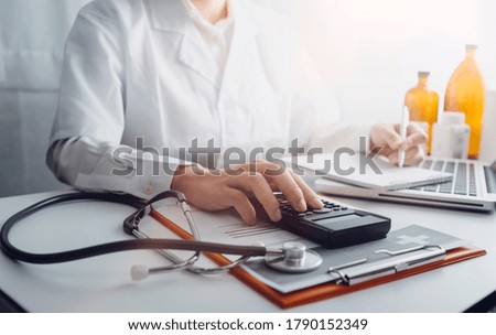 Medical technology concept The doctor works with mobile phones, headphones and tablets. Digital laptop Pressing the calculator in the modern office at the hospital in the morning