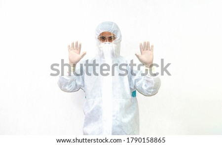 Man in full protective hazmat suit,face shield, N95 ,surgical gloves on isolate background. Doctor wearing PPE ,Face Shield ,N95 ,surgical gloves. Covid-19 virus protection outbreak concept. 