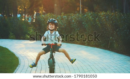 Little Boy a bicycle on green pasture. Child cycling outdoors in helmet. Posture kid riding bikes in nature. cartoon riding bicycle on path. Vector illustrations isolated on white background.