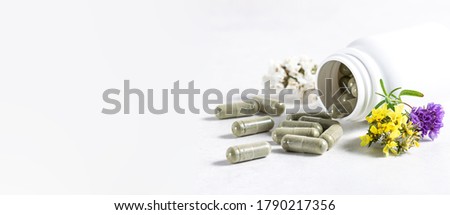 Long wide banner with natural herbal pills for detox and immunity support in pandemic time. Big herbal pills in white plastic bottle on white background with copy space for your text. Royalty-Free Stock Photo #1790217356