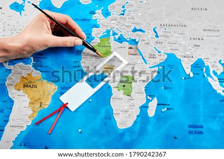 Woman's hand is scratching a scratch map