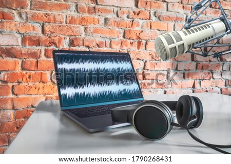 Microphone, laptop and headphones on the table