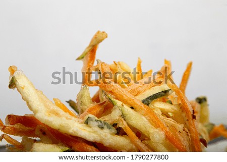 Close up of Japanese dishes of variety of fried vegetables on white background. Vegetable tempura