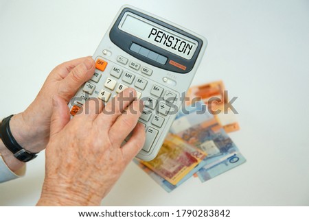 An elderly woman holds a calculator in her hands and calculates expenses. Financial concept