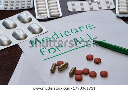 The Medicare for all sign is written on the sheet in green letters, next to the pills.