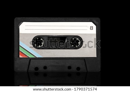 Retro old cassette on a black background.