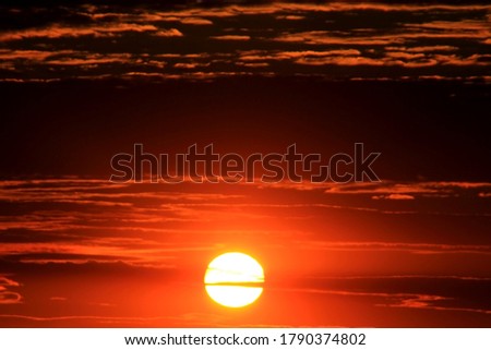 orange sun in the sky at sunset