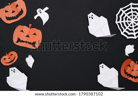 Handmade Halloween paper cut decor on Black background. Halloween background. Copy space