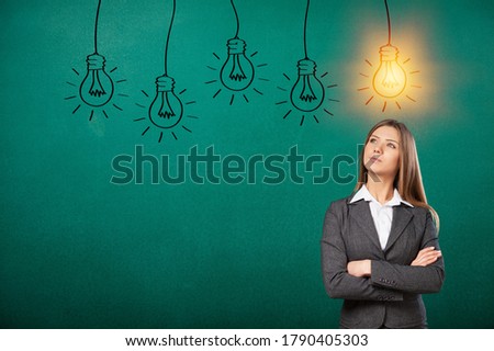 Business person looking for new idea with light bulbs on the background