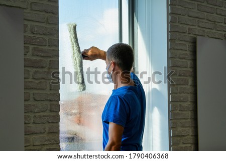 
Professional cleaner cleans the window photo