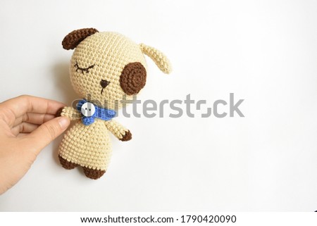 Cute crochet puppy, love dog/pet, baby animal in white background, a woman holding a handmade toy for kid