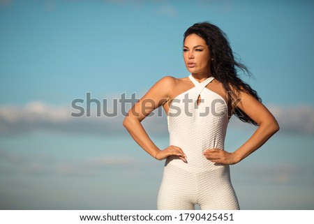 beautiful young female in white tracksuit in summer