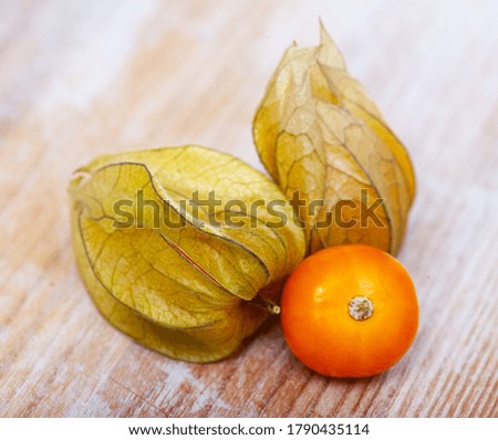 Orange physalis fruit on wooden desk, nobody
