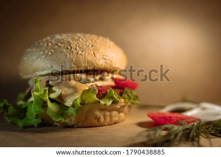 Delicious cheeseburger with meat, sauce and vegetables