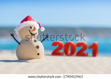 Sandy Christmas Snowman is welcoming the New Year of 2021 on a beautiful beach
