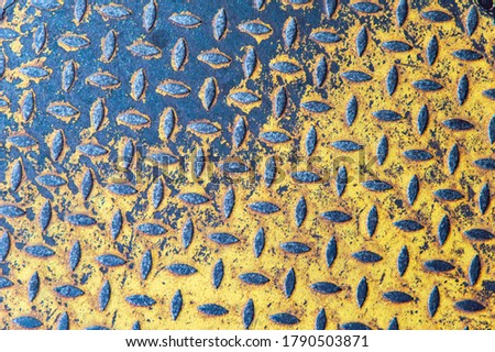metal grunge background covered with abraded yellow paint, rust