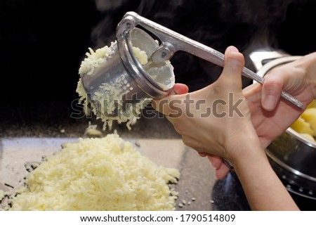 Squeezing potatoes to make gnocchi Royalty-Free Stock Photo #1790514809