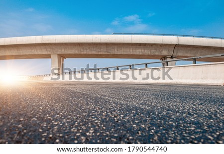 Clear sky, highway pavement under the overpass