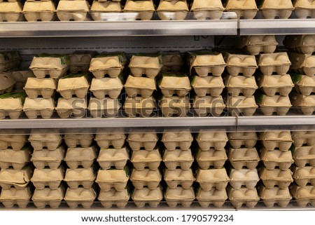 Showcase with eggs in a supermarket. Eco-friendly packaging 