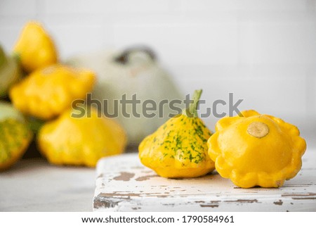 small yellow squash on a wooden board, close up