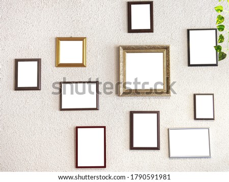 mockup image. different size picture framed hanging on the gray wall. Blank of wooden frames picture hanging on concrete wall background. Various frame mockups.