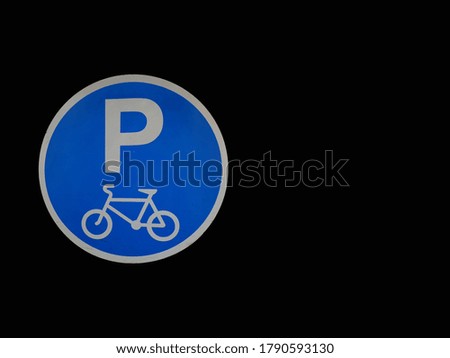 Bicycle parking symbol on black background