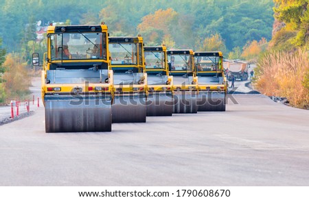 Heavy Vibration roller at asphalt pavement works (road repairing). Five road rollers working in road construction. Road construction