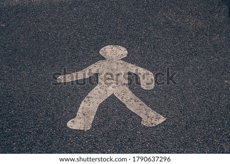 Signage character on the road. Painted man