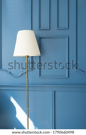 white floor lamp over blue background