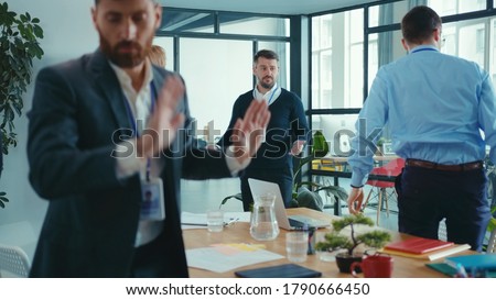 Sad caucasian businessman failed at public presentation conference. Displeased business people coworkers leaving meeting room. Bad day. Royalty-Free Stock Photo #1790666450