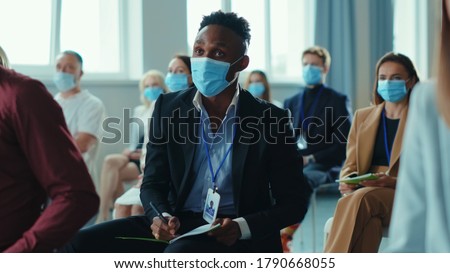 African american entrepreneur asks question on education forum business seminar of corporate company. Diversity of business people. Presentation. Health care. Virus protection. Royalty-Free Stock Photo #1790668055