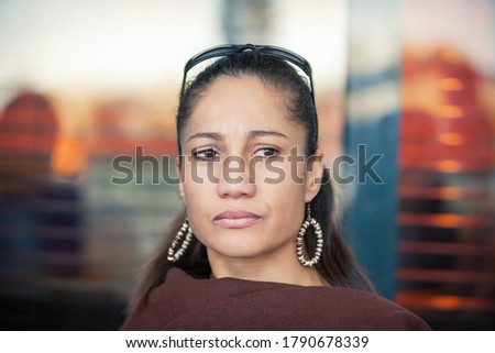 mixed race woman outdoors crying, outdoors on a terrace
