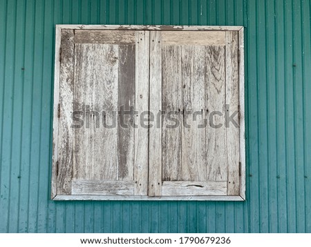 Vintage style wooden window on green background