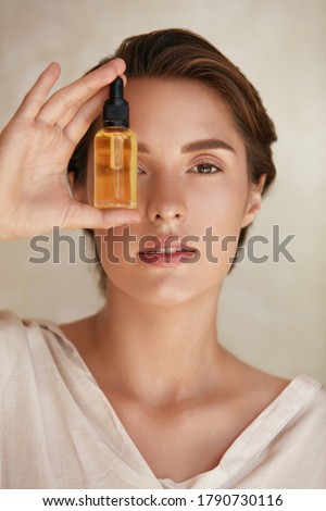 Skin Care. Beauty Portrait Of Woman Holding Bottle With Dropper Near Face. Model Using Natural Cosmetic Product For Hydrated, Glowing And Healthy Facial Derma. Essential Oil For Anti-Aging Therapy. Royalty-Free Stock Photo #1790730116