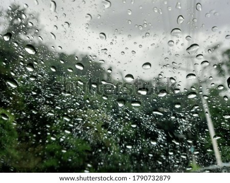 a picture to blur in raining season and beautiful natural, water drop on the window car