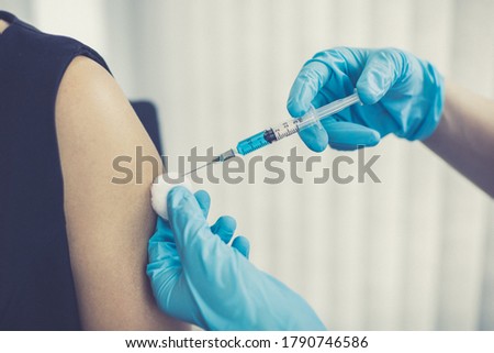 Doctor is vaccinating women with antibiotics or new antibodies to prevent the spread of the virus, Vaccination against communicable diseases concept