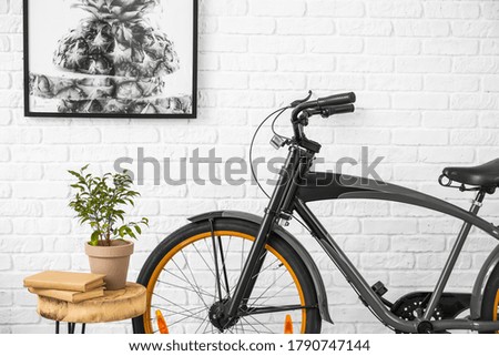 Interior of modern room with table and bicycle