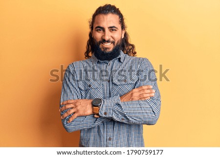 Young arab man wearing casual clothes happy face smiling with crossed arms looking at the camera. positive person. 