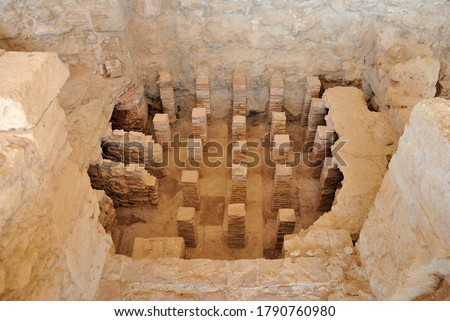 View of Public Bath and a caldarium with an underfloor heating system at the Neolithic period Kourion Ancient city in Cyprus Royalty-Free Stock Photo #1790760980