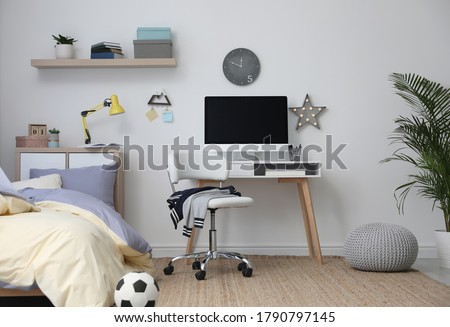Stylish teenager's room interior with comfortable bed and workplace Royalty-Free Stock Photo #1790797145