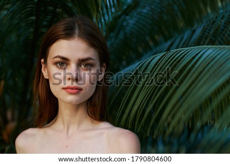 Woman portrait natural look green leaves of palm tree park