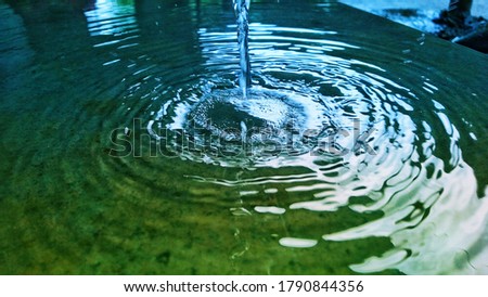 The concentric circles of the water waves. This picture depicts the beauty of nature.The combination of bluish shade with the yellow-greenosh shade makes the picture more impressive.This is beautiful.