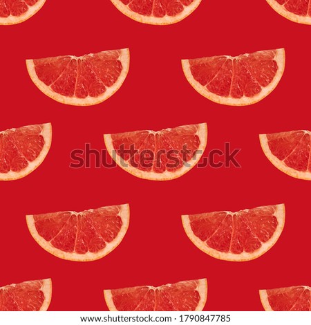 Slices of ripe grapefruit on a bright red background. Geometric seamless pattern
