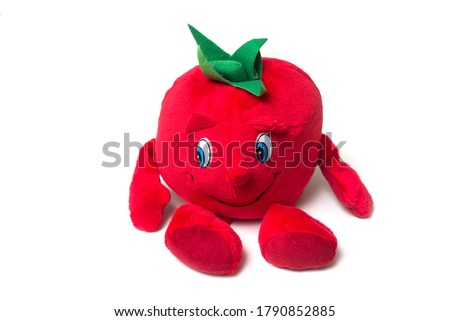 closeup of funny plush in shaped tomato on white background