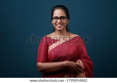 Portrait of a happy woman of Indian origin wearing traditional dress sari Royalty-Free Stock Photo #1790854862