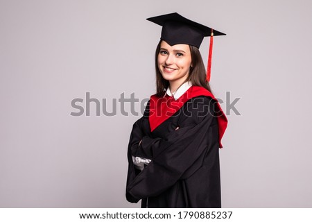 Educational theme: graduating student girl in an academic gown. Isolated over white background. Royalty-Free Stock Photo #1790885237