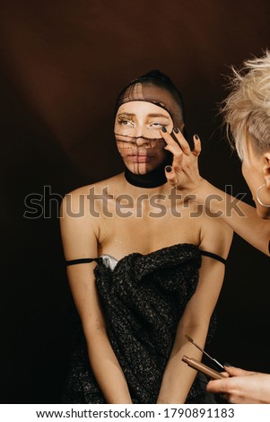 Professional make up artist do make up on unusual strange model. Creative editorial shooting for magazines
