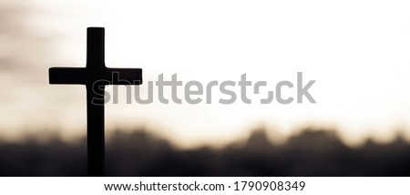 Silhouette cross against the sky At Sunset. Dramatic nature background. Crucifixion Of Jesus Christ. Religion concept. Black and white photo