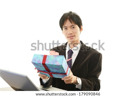 Smiling businessman with present