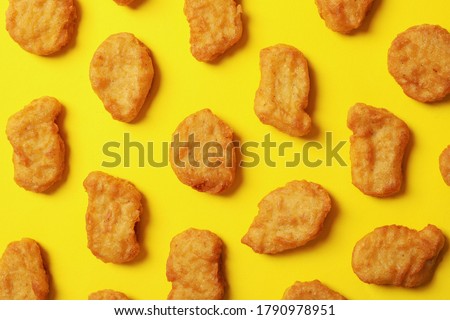 Flat lay with fried chicken nuggets on yellow background Royalty-Free Stock Photo #1790978951